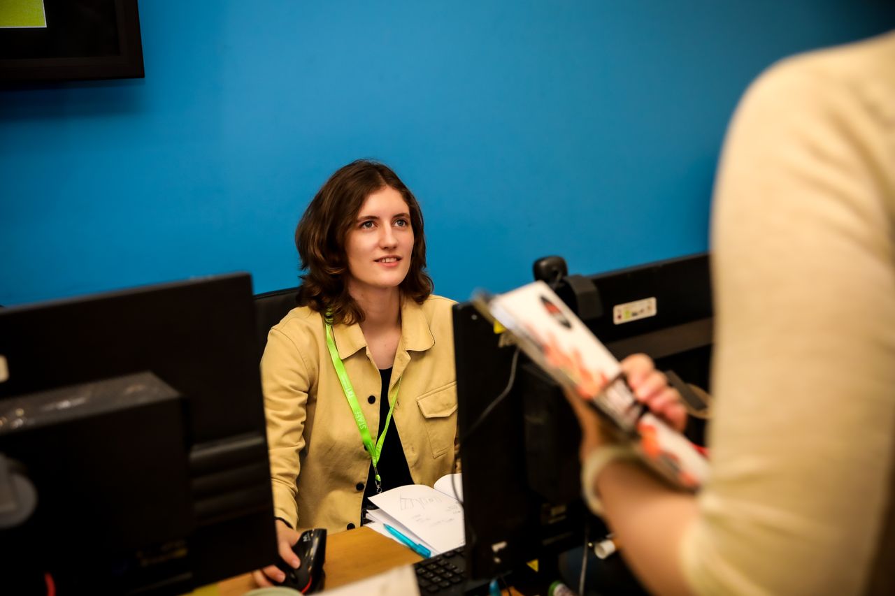 Staff member behind reception desk