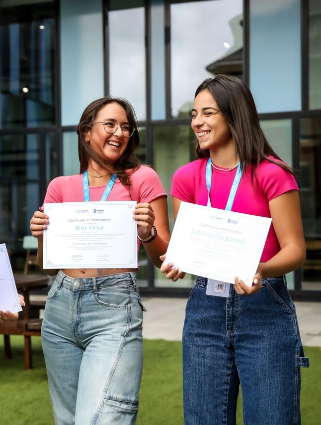female students holding certificates
