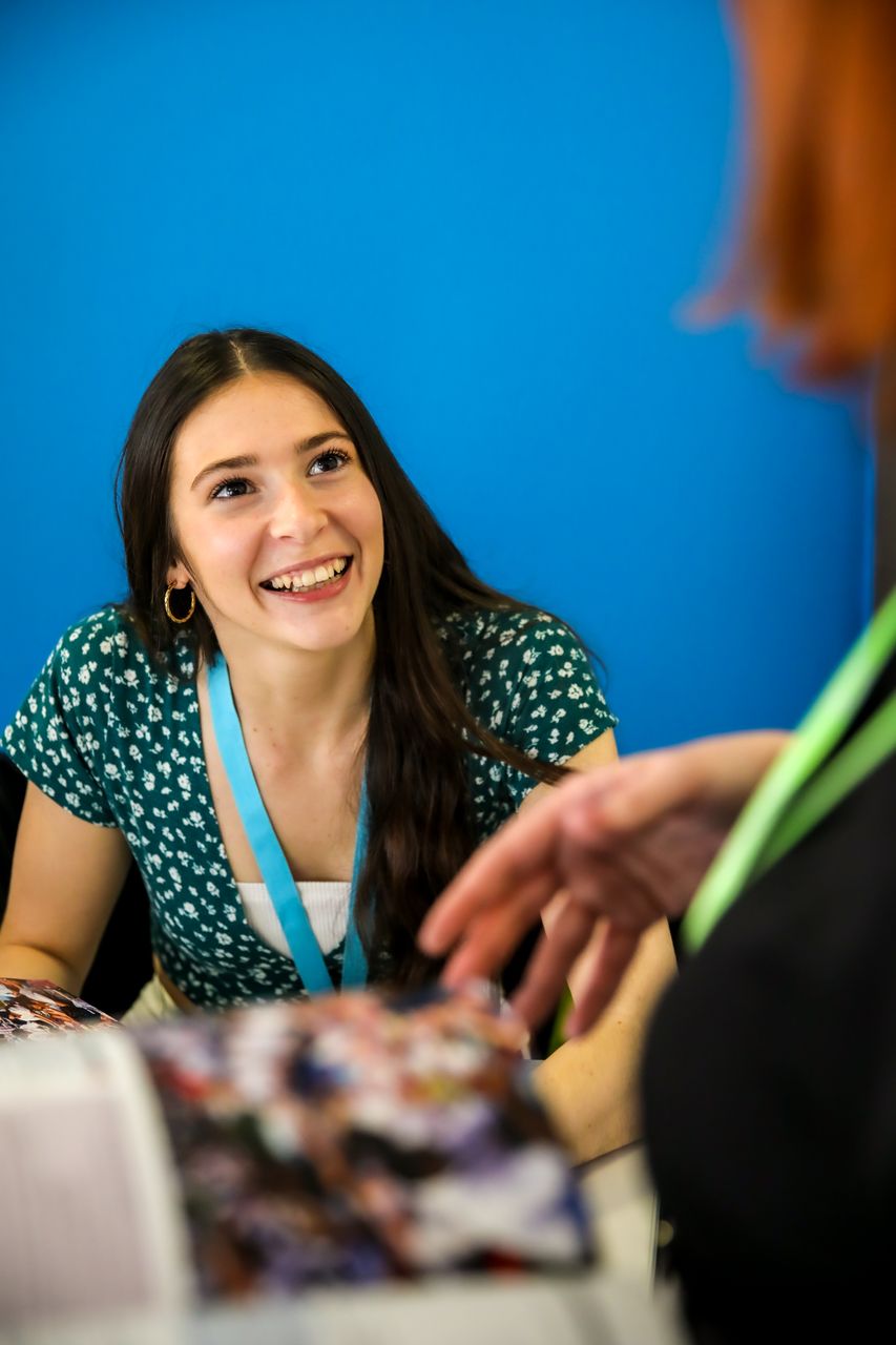 female student smiling at teacher in class