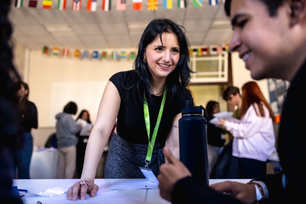 Teacher smiling with students in a classroom
