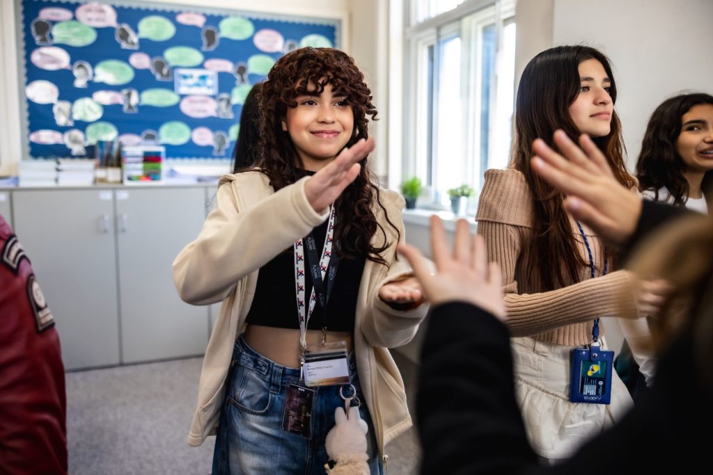 Girls clapping in a classroom