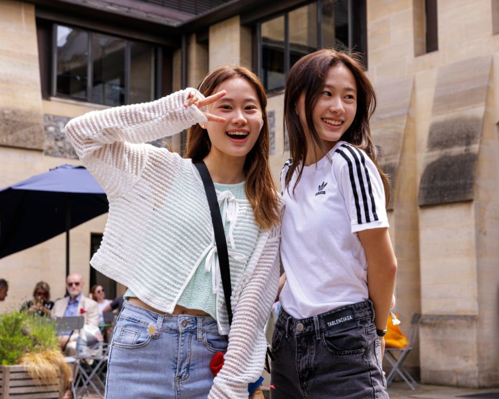 students outside school posing for photo